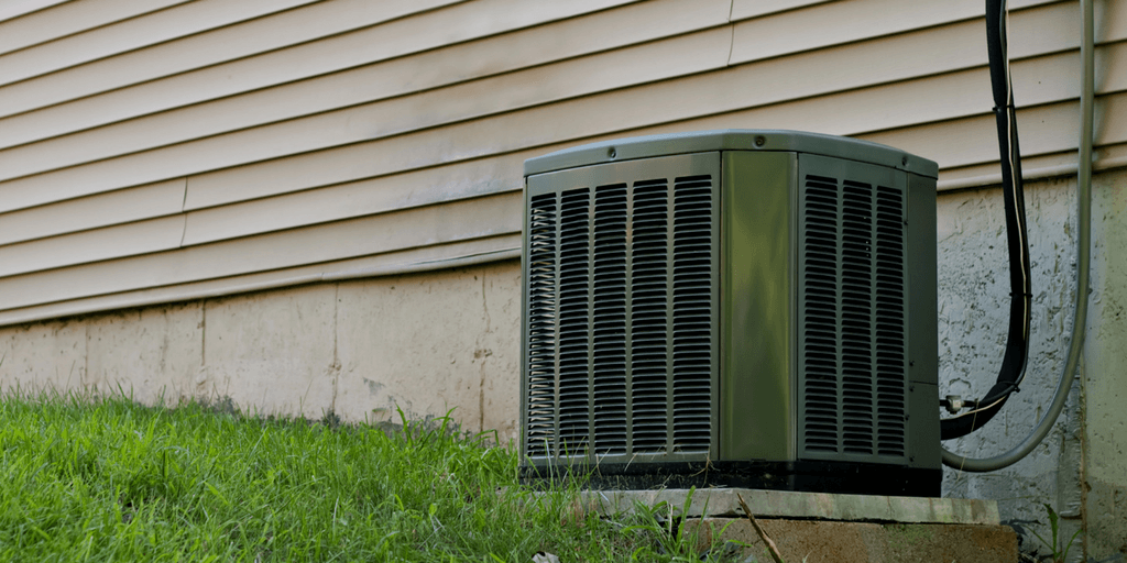 outdoor air conditioning unit along the exterior wall of a house