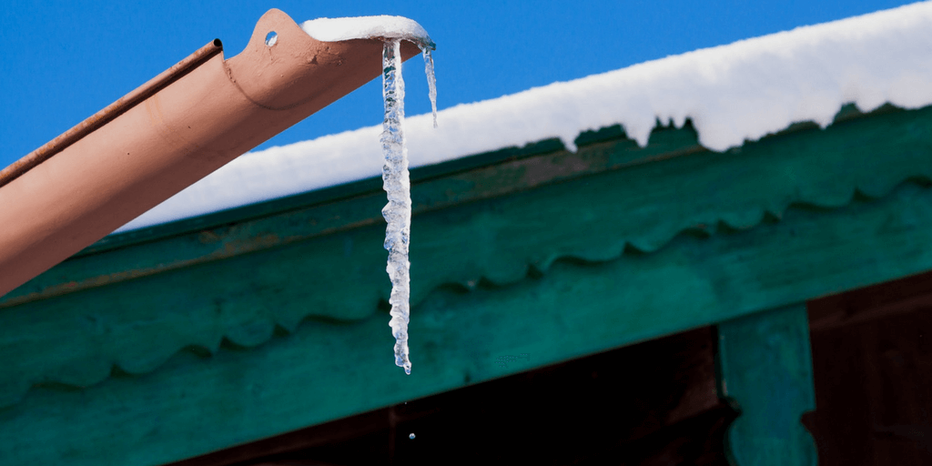 icicle hanging from the end of a gutter