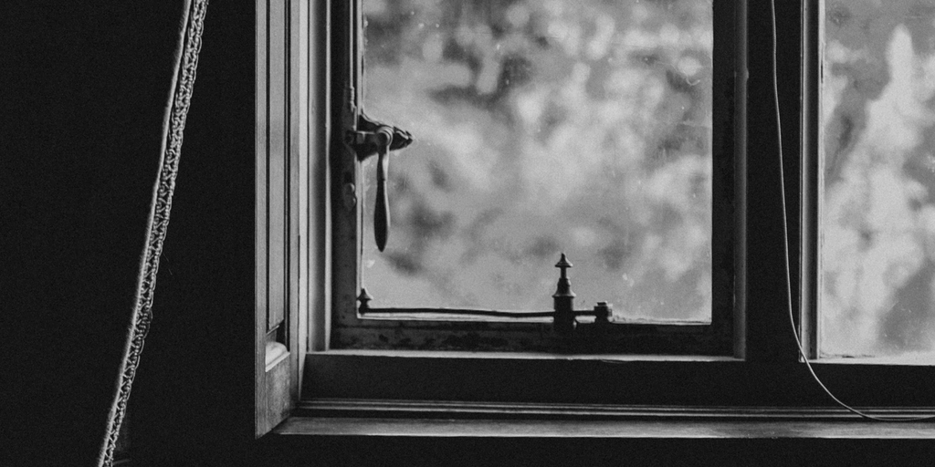 black and white picture of the bottom corner of a window