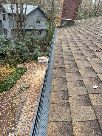 Micro-mesh gutter guard keeping leaves and debris out of gutter system while maintaining water flow